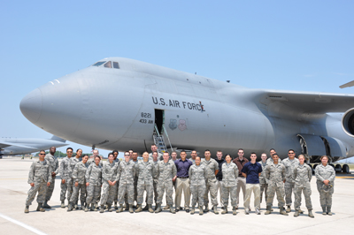 Photo of Airmen standing in from of a C-5 Galaxy.